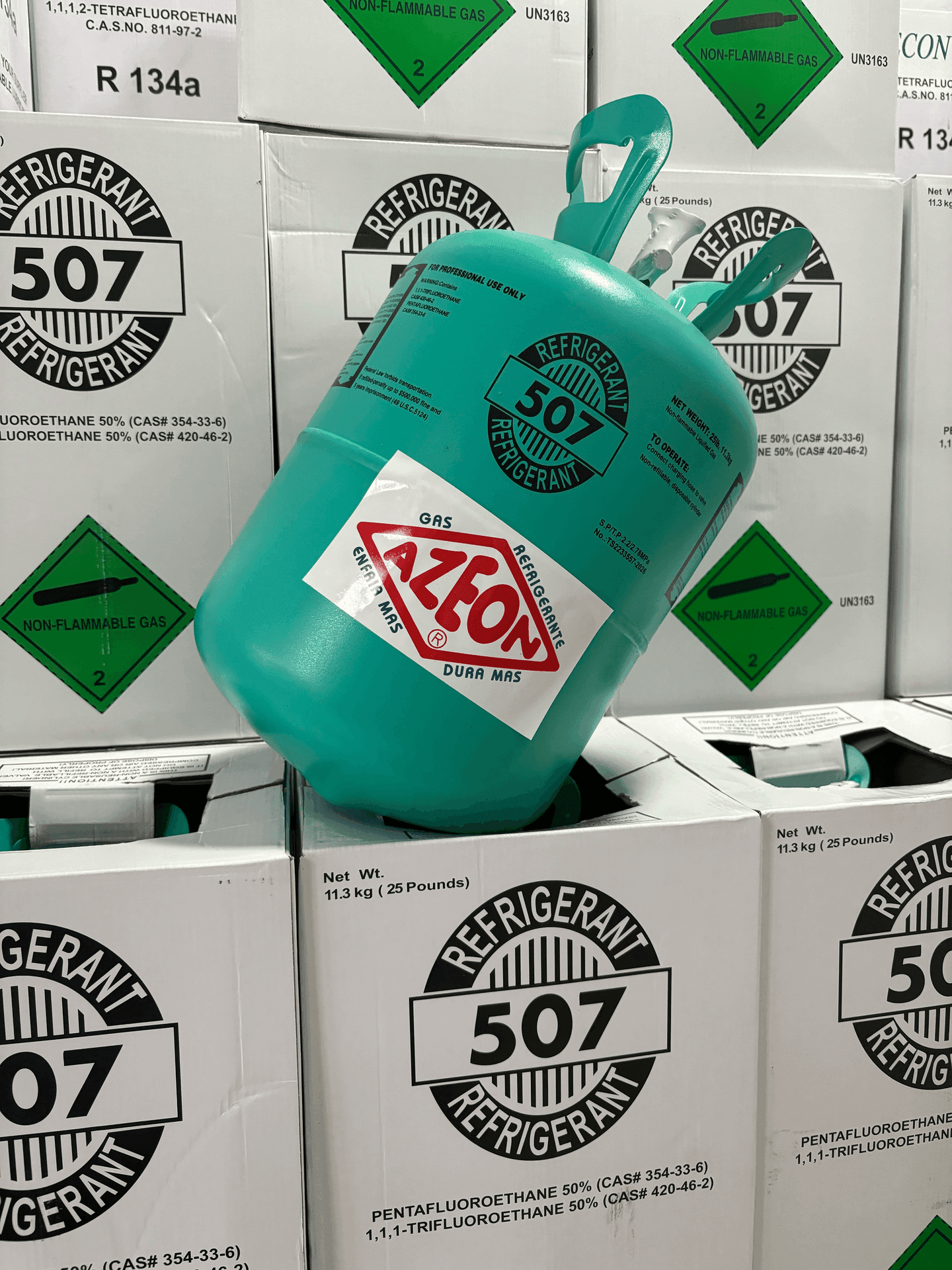 Green refrigerant tank labeled 507 against stack of identical boxes with non-flammable gas labels.