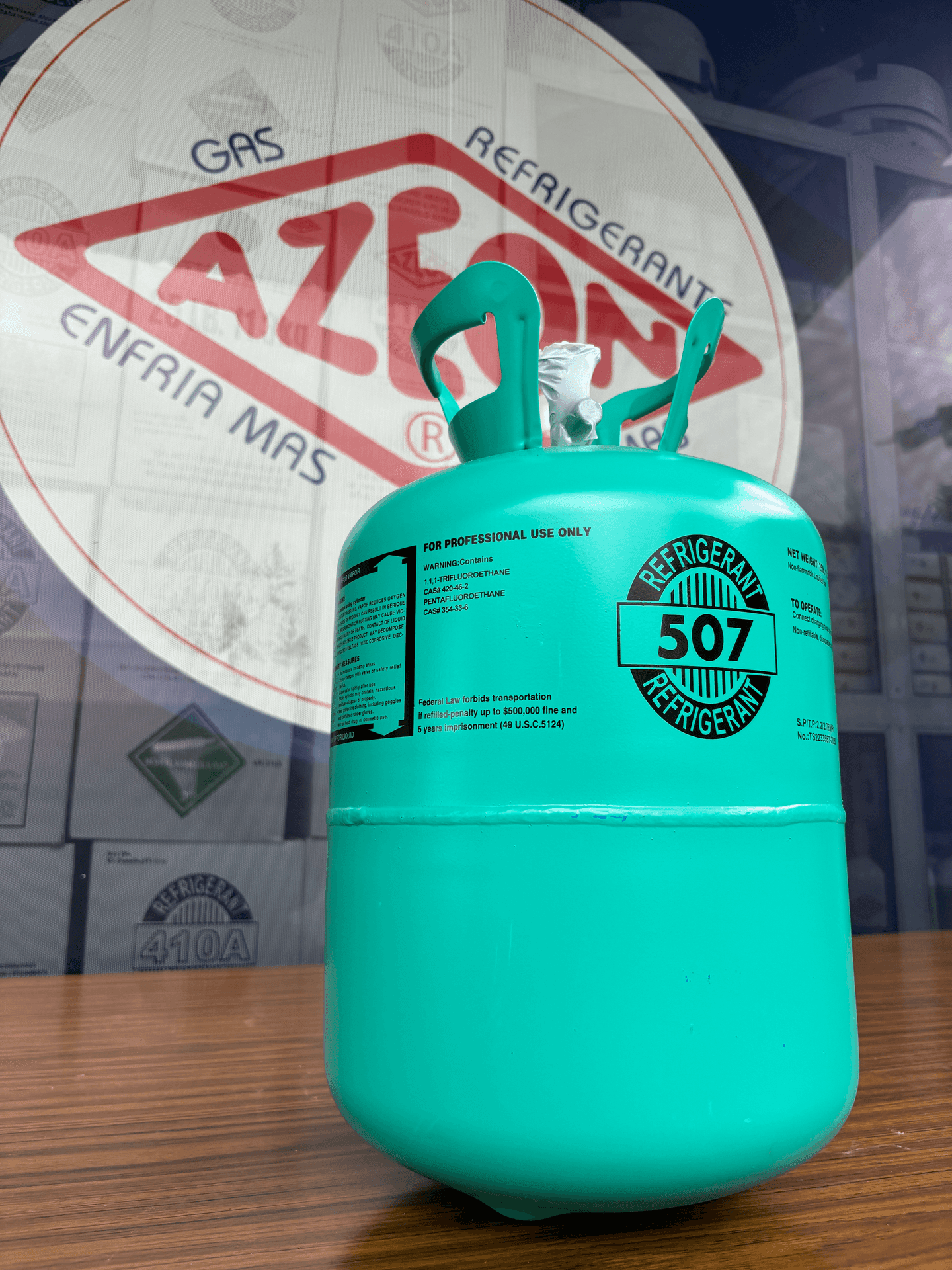 Close-up of a turquoise refrigerant gas cylinder with label, placed on a wooden surface.